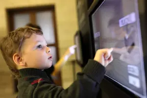 A child interacting with a touchscreen display