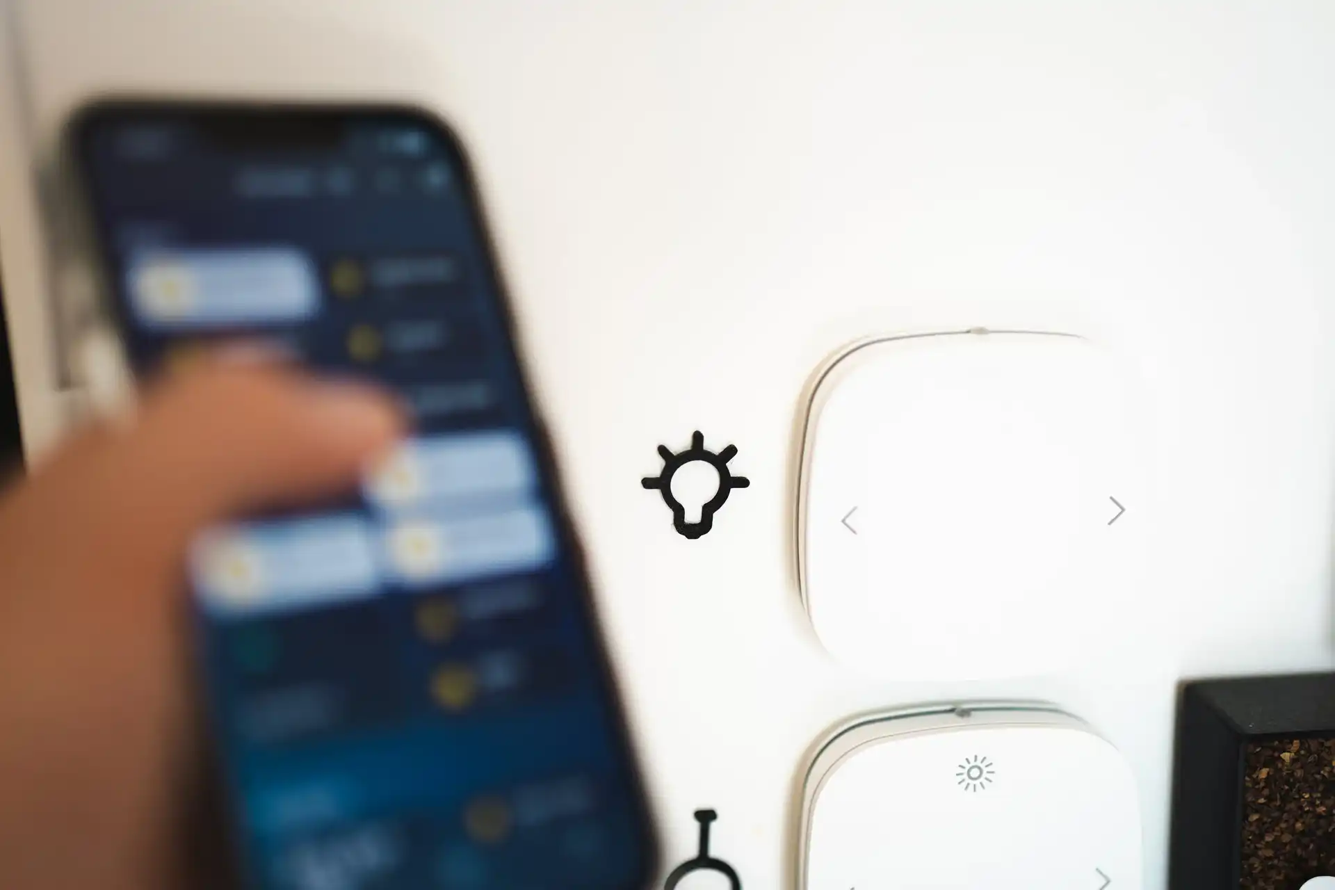 A smartphone with home automation controls displayed